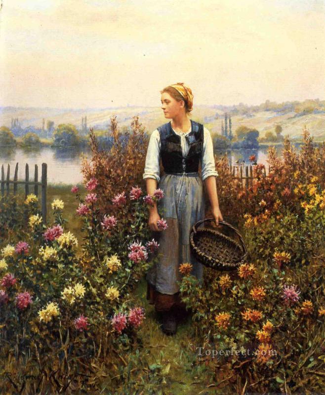 Chica con una cesta en un jardín paisana Daniel Ridgway Knight Pintura al óleo